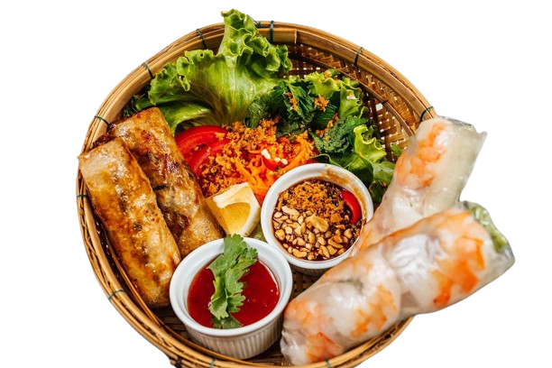 Bamboo basket of spring rolls, salad rolls and dipping sauces